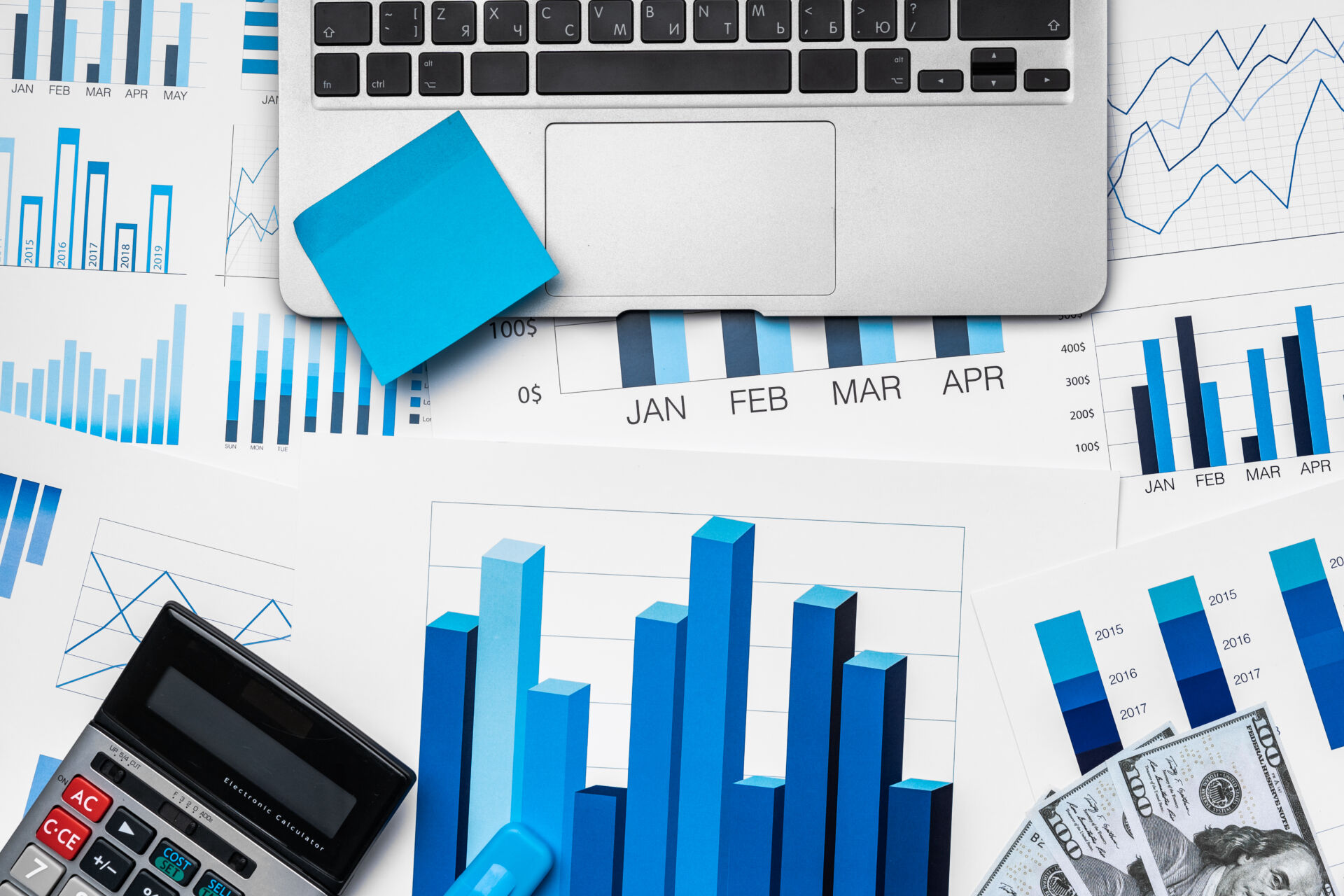 Financial paper with charts and diagrams on gray table top view